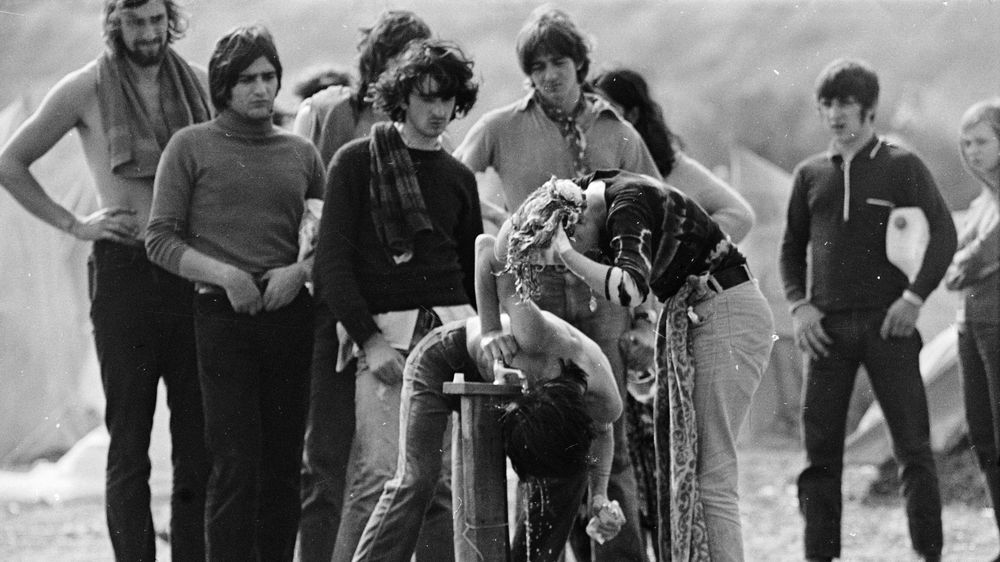 Festival-Goers Queue up to Wash at a Tap