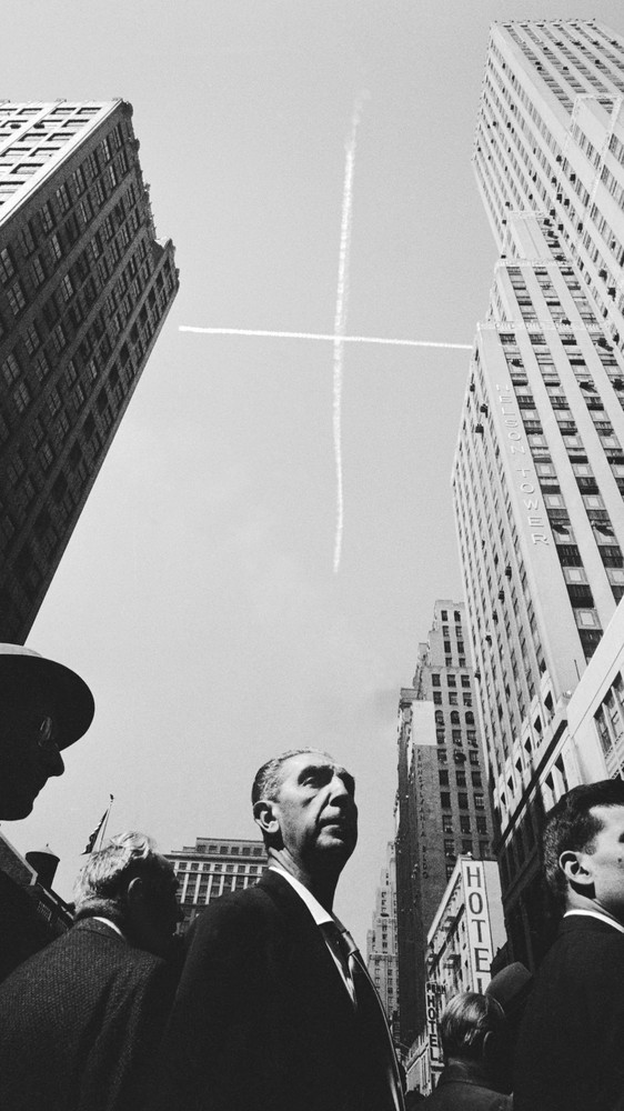 Sky Figure Above City Crowd